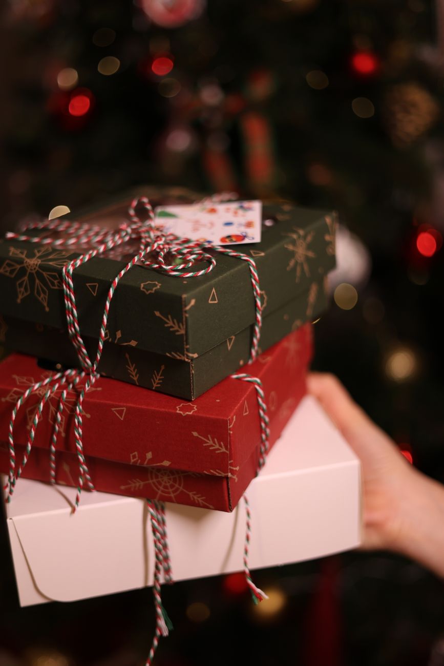 festive christmas gift boxes by the tree